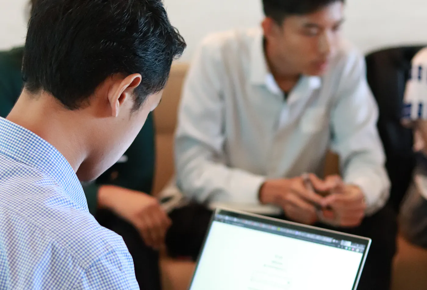 Marketing strategy team planning campaign delivery around laptops